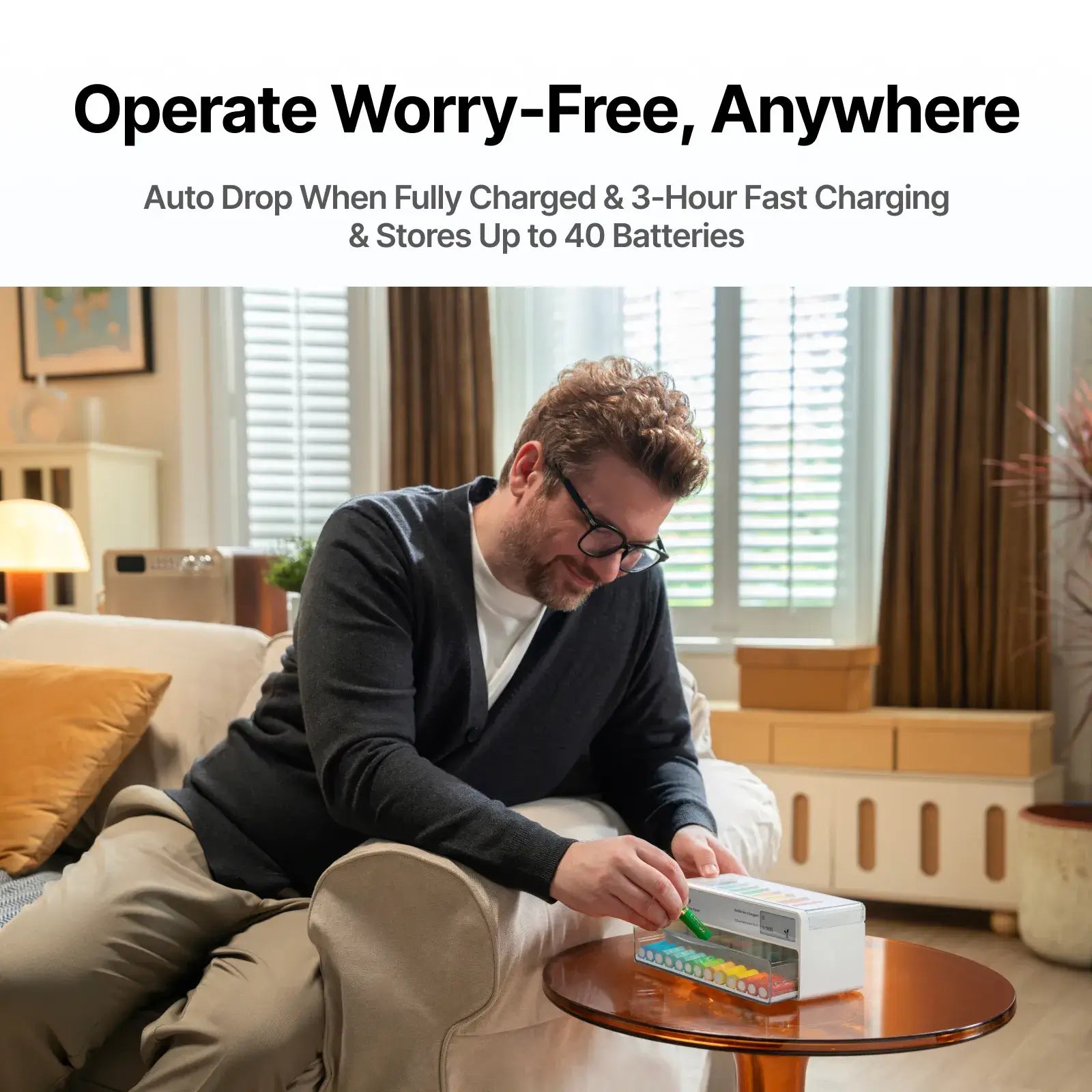 Man sitting on a couch in a living room with a product on a small table.